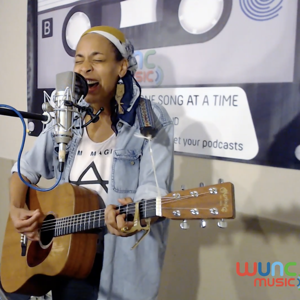 Kamara Thomas singing and playing guitar